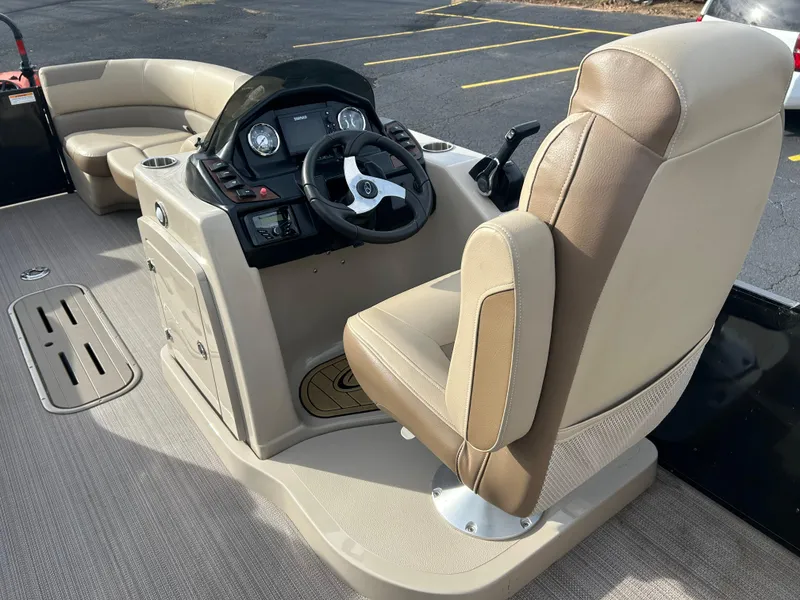 Slide: The Image of 2022 Veranda Relax VR25RC boat interior with steering console and beige seating. - 7