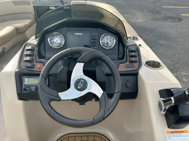 Slide: The Image of 2022 Veranda Relax VR25RC boat dashboard with steering wheel and control panel. - 8