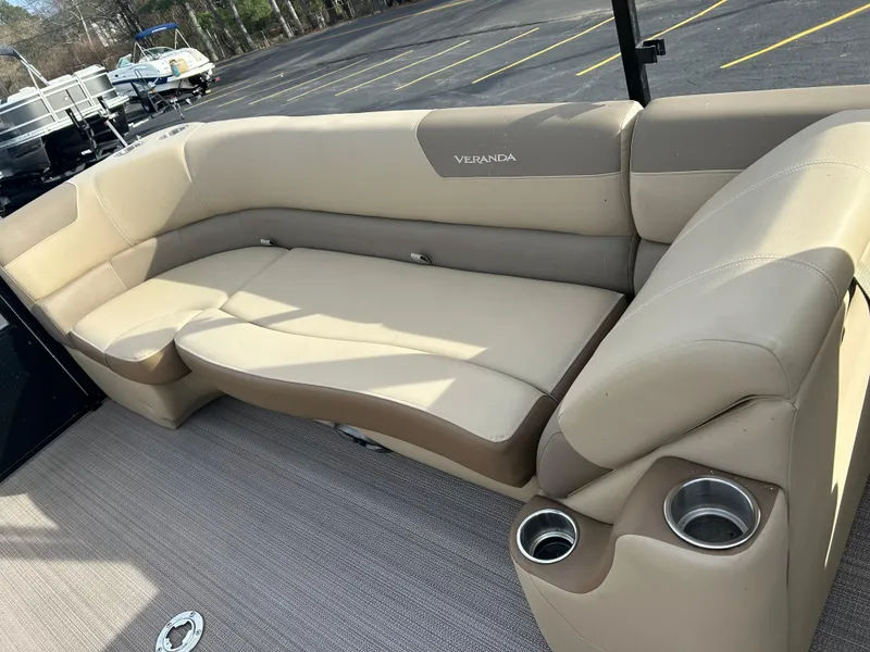 Slide: The Image of 2022 Veranda Relax VR25RC boat interior with beige seating and cup holders. - 9