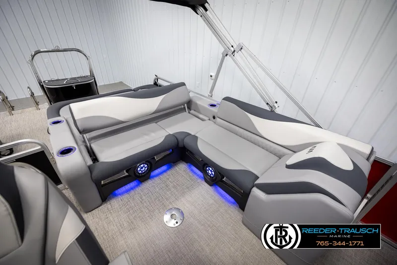 Slide: The Image of 2025 Avalon LSZ VRB boat interior with gray seating and blue LED lighting. - 23