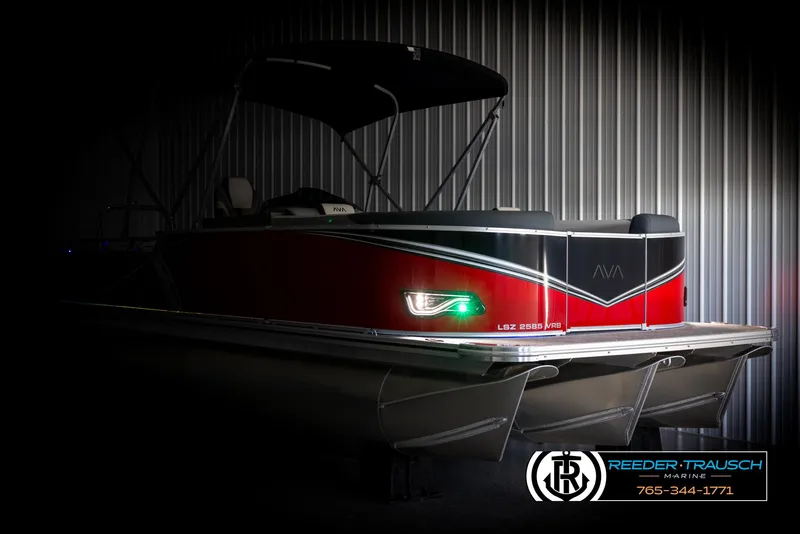Slide: The Image of 2025 Avalon LSZ VRB pontoon boat with sleek red design and modern lighting in a dimly lit setting. - 4