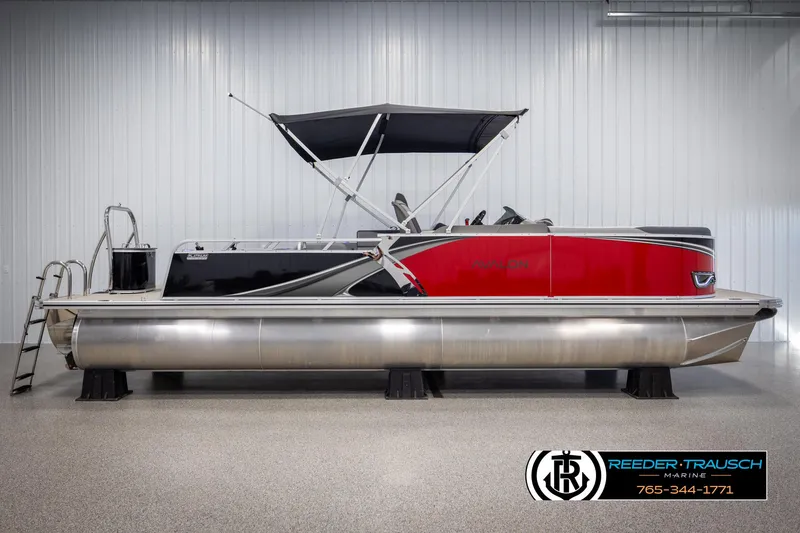 Slide: The Image of 2025 Avalon LSZ VRB pontoon boat with red and black design, displayed indoors. - 5