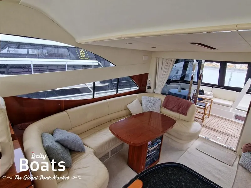 Slide: The Image of Luxurious interior of 2006 Fairline 50 yacht with elegant seating and wooden table. - 11