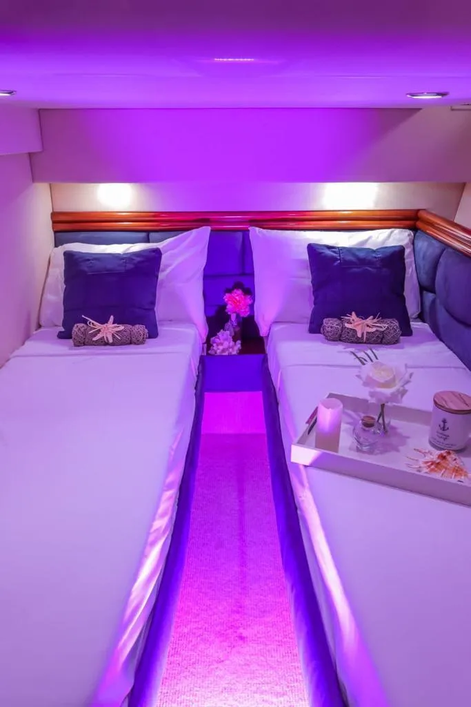 Slide: The Image of Luxurious 2006 Fairline 50 yacht cabin with ambient purple lighting and elegant decor. - 15