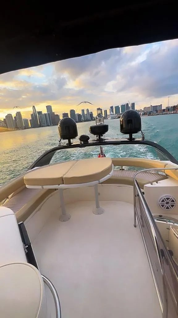 Slide: The Image of 2006 Fairline 50 yacht cruising with city skyline at sunset. - 4