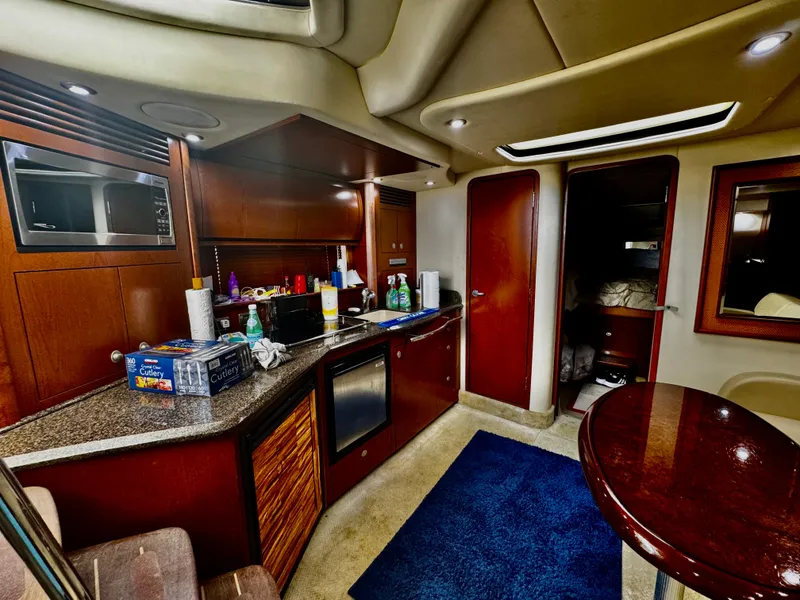 Slide: The Image of Interior of 2007 Sea Ray 40 Sundancer yacht with modern kitchen amenities. - 11