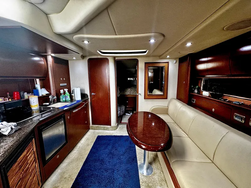 Slide: The Image of Interior of 2007 Sea Ray 40 Sundancer yacht with modern kitchen and seating area. - 12