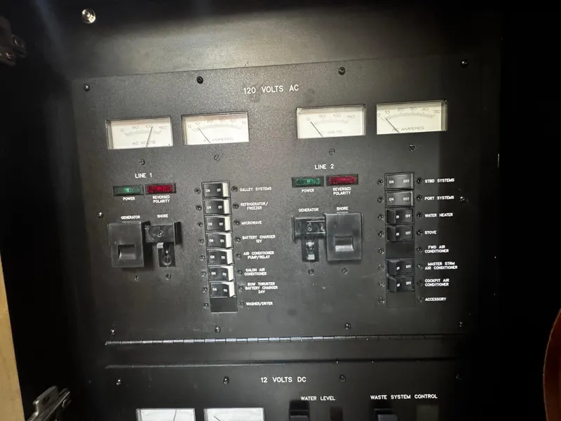 Slide: The Image of Electrical panel of a 2007 Sea Ray 40 Sundancer boat, showing AC and DC controls. - 16