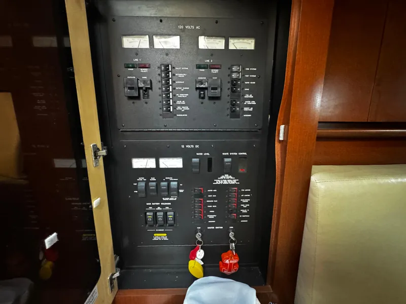 Slide: The Image of Electrical panel inside 2007 Sea Ray 40 Sundancer yacht, showcasing circuit breakers and controls. - 18