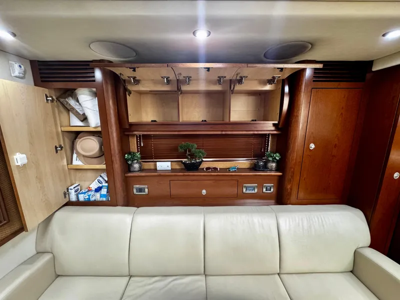 Slide: The Image of Interior of 2007 Sea Ray 40 Sundancer with beige sofa, wooden cabinets, and decorative plants. - 24