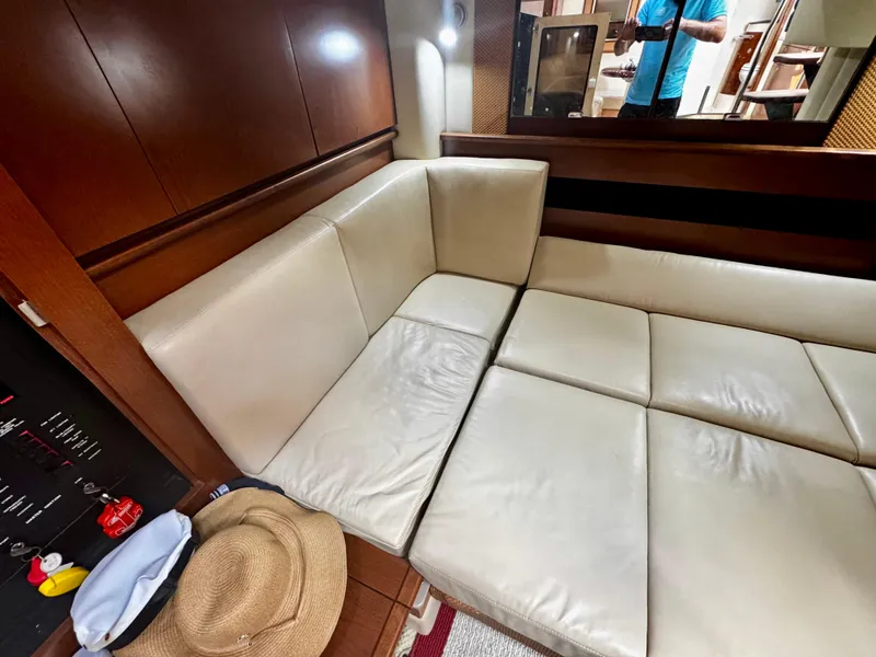 Slide: The Image of Interior of 2007 Sea Ray 40 Sundancer with beige leather seating and wooden accents. - 32