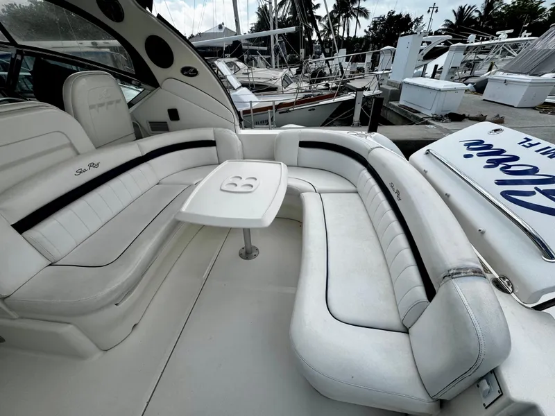 Slide: The Image of 2007 Sea Ray 40 Sundancer yacht with white leather seating and table, docked at marina. - 49