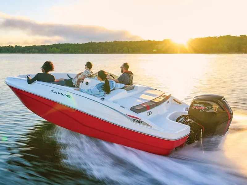 Slide: The Image of 2025 Tahoe T18 boat cruising on a lake at sunset with passengers. - 7