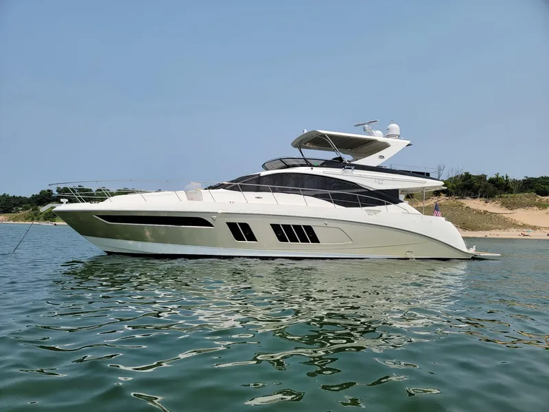 Slide: The Image of 2015 Sea Ray L650 Fly yacht on calm water, side view. - 1