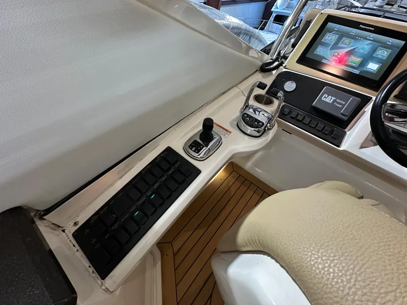 Slide: The Image of Cockpit controls of 2015 Sea Ray L650 Fly yacht with navigation display and joystick. - 10