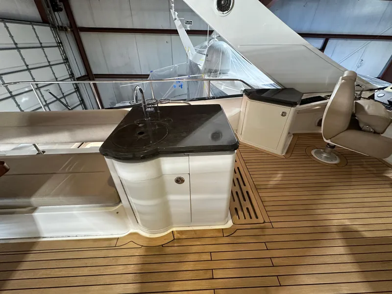 Slide: The Image of 2015 Sea Ray L650 Fly yacht interior with teak flooring and sleek countertop. - 15