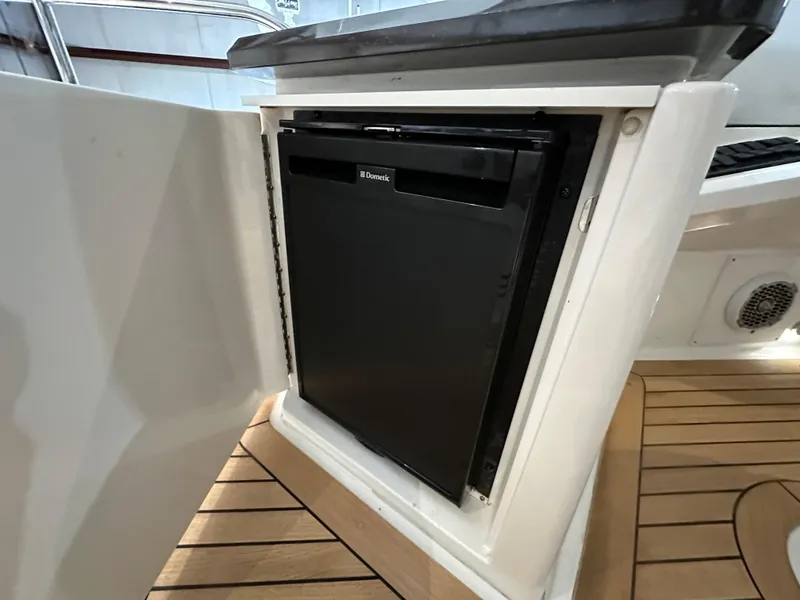 Slide: The Image of Built-in fridge on 2015 Sea Ray L650 Fly yacht, open cabinet view. - 17