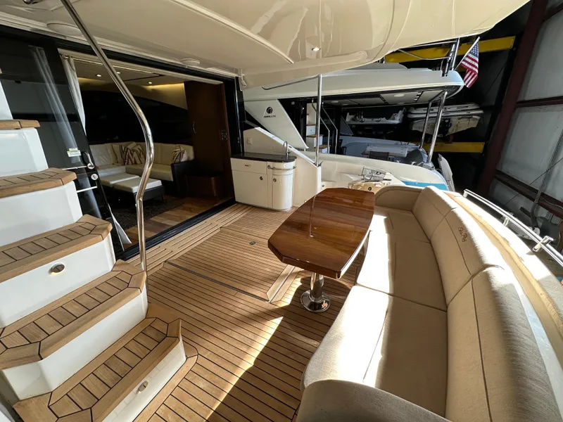 Slide: The Image of Luxurious 2015 Sea Ray L650 Fly yacht interior with elegant seating and wooden flooring. - 19