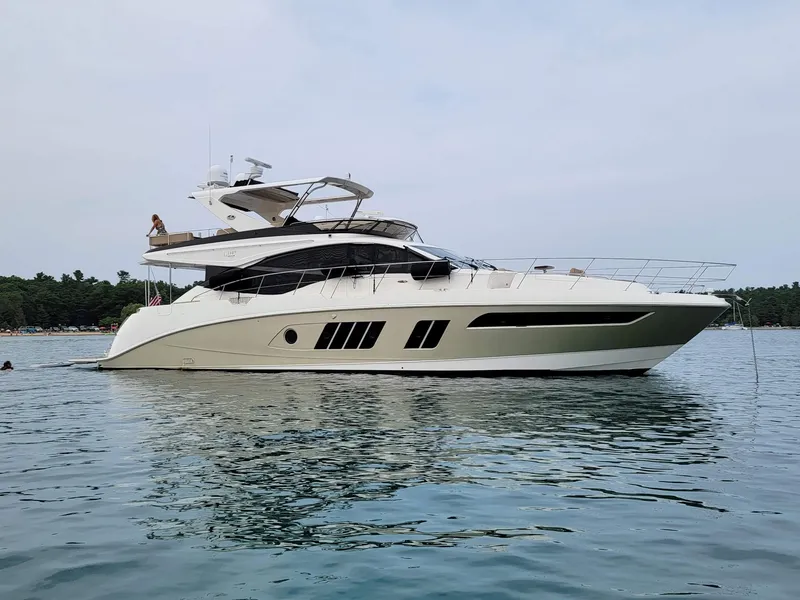 Slide: The Image of 2015 Sea Ray L650 Fly yacht on calm water, side view. - 2