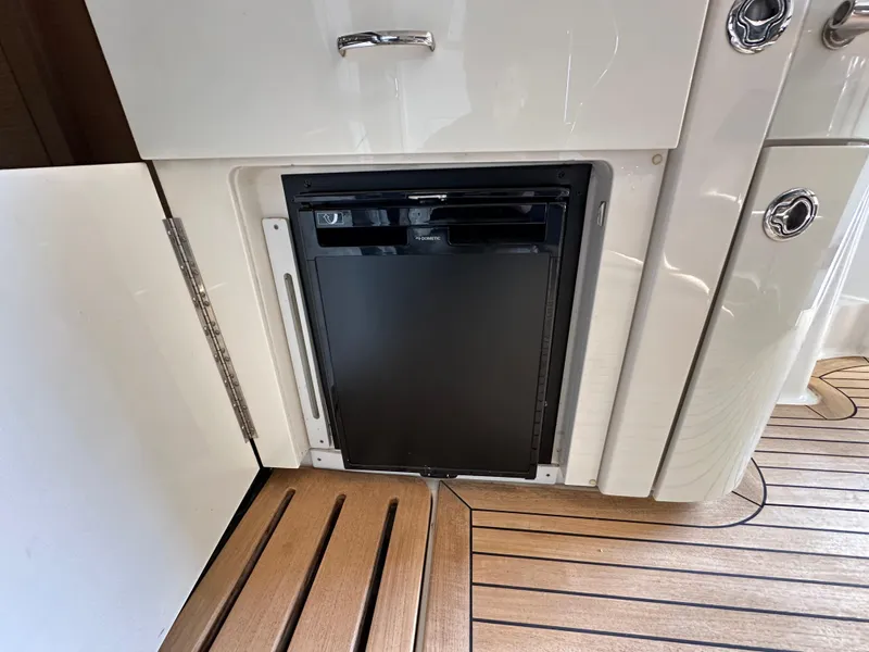 Slide: The Image of Built-in refrigerator on 2015 Sea Ray L650 Fly yacht with wooden flooring. - 22