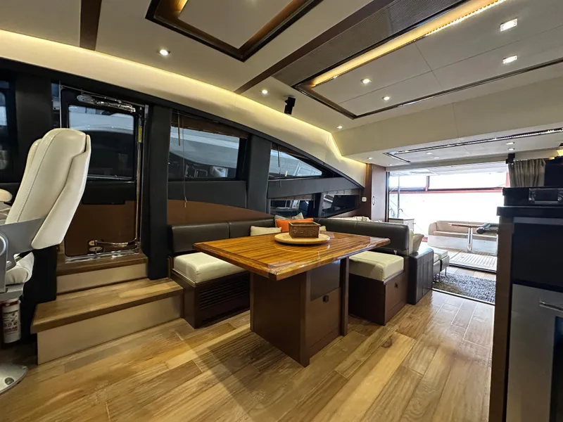 Slide: The Image of Luxurious interior of a 2015 Sea Ray L650 Fly yacht with elegant wood flooring and modern seating. - 30