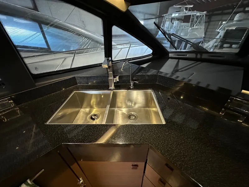 Slide: The Image of Luxurious kitchen sink area in 2015 Sea Ray L650 Fly yacht interior. - 32
