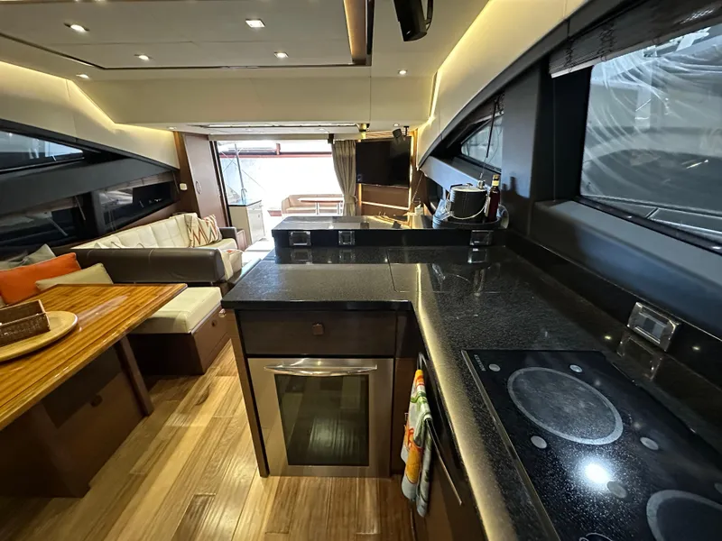 Slide: The Image of Luxurious interior of 2015 Sea Ray L650 Fly yacht with modern kitchen and seating area. - 34