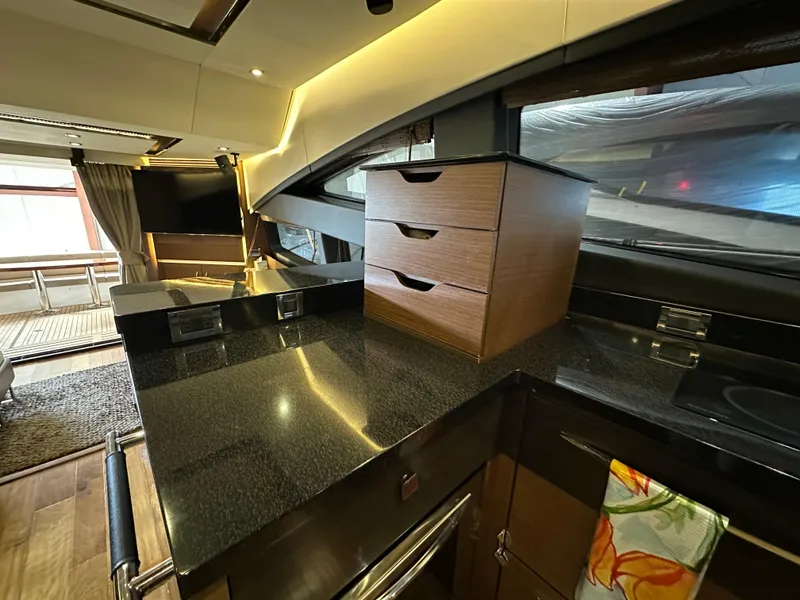 Slide: The Image of Luxurious interior of 2015 Sea Ray L650 Fly yacht with sleek countertops and modern cabinetry. - 35