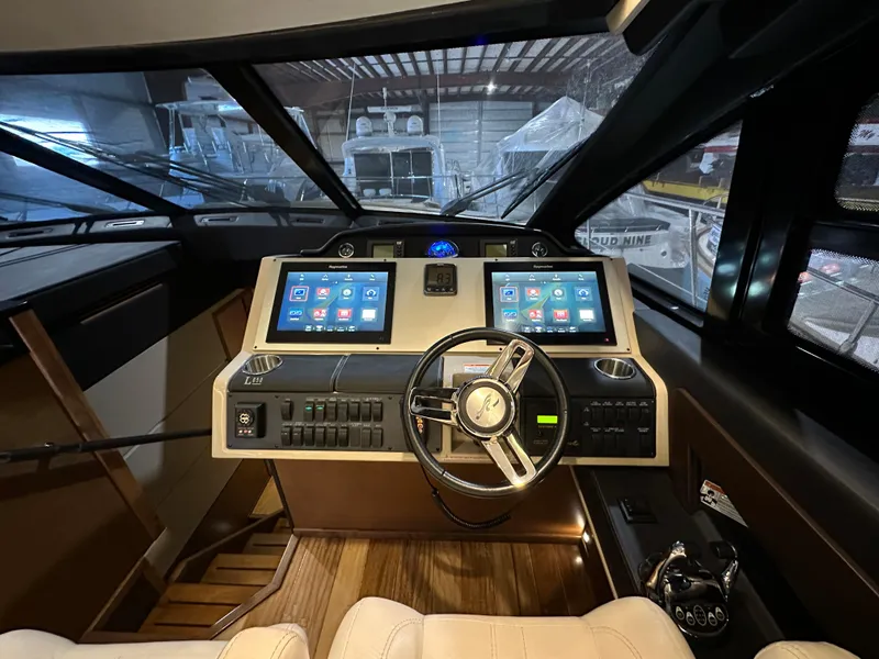Slide: The Image of 2015 Sea Ray L650 Fly yacht helm with dual touchscreen displays and modern controls. - 42