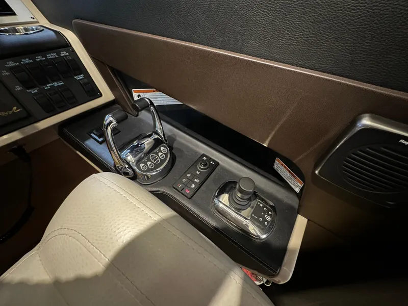 Slide: The Image of Control panel of a 2015 Sea Ray L650 Fly yacht, featuring modern navigation equipment. - 43