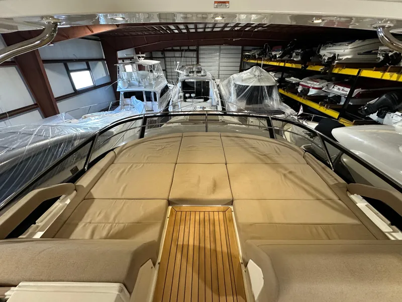 Slide: The Image of 2015 Sea Ray L650 Fly yacht in storage, showcasing spacious deck and luxurious design. - 6