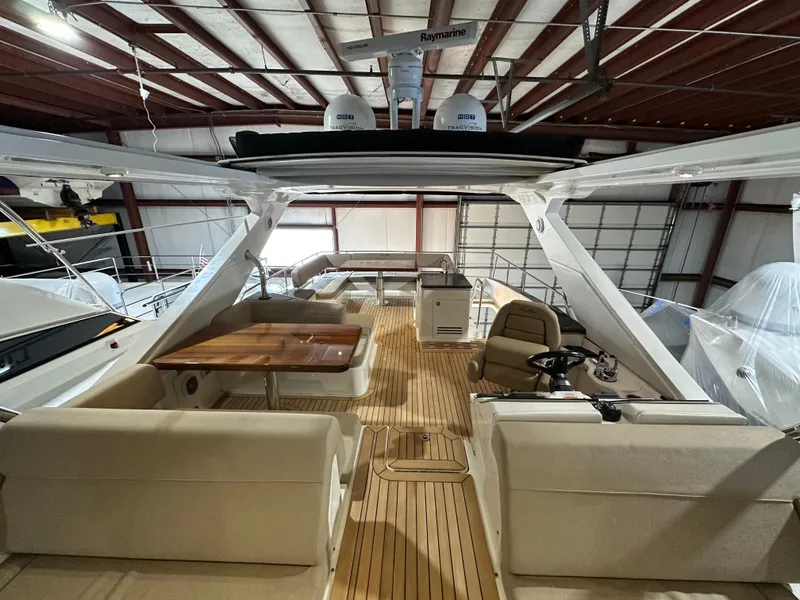 Slide: The Image of 2015 Sea Ray L650 Fly yacht interior with spacious seating and wooden deck. - 7