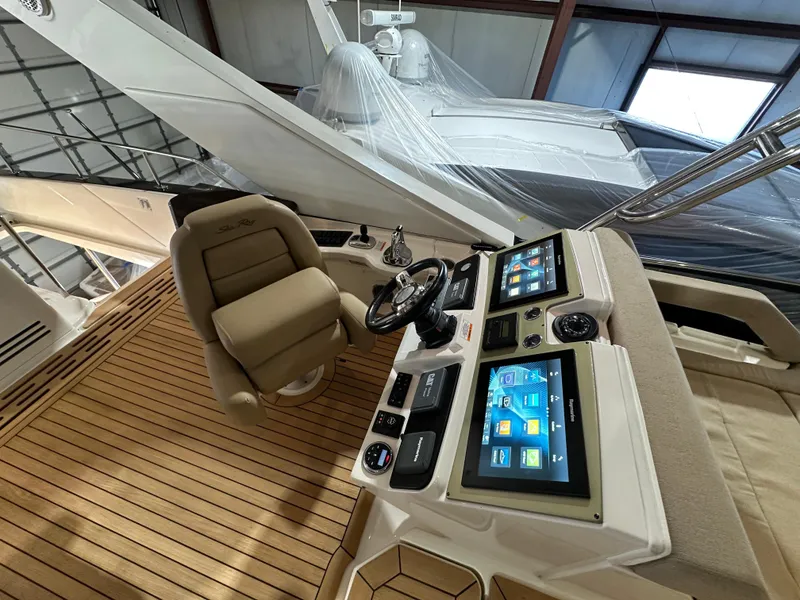 Slide: The Image of 2015 Sea Ray L650 Flybridge helm with dual screens and captain's chair. - 8