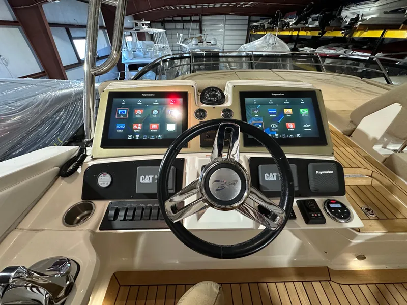 Slide: The Image of 2015 Sea Ray L650 Fly yacht helm with dual touchscreens and modern controls. - 9