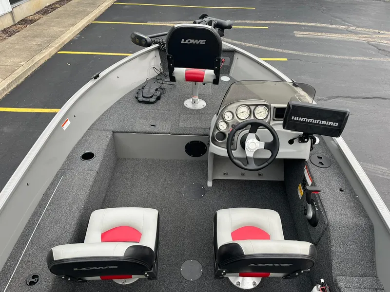 Slide: The Image of 2011 Lowe FM 165 fishing boat interior with steering console and seating. - 10