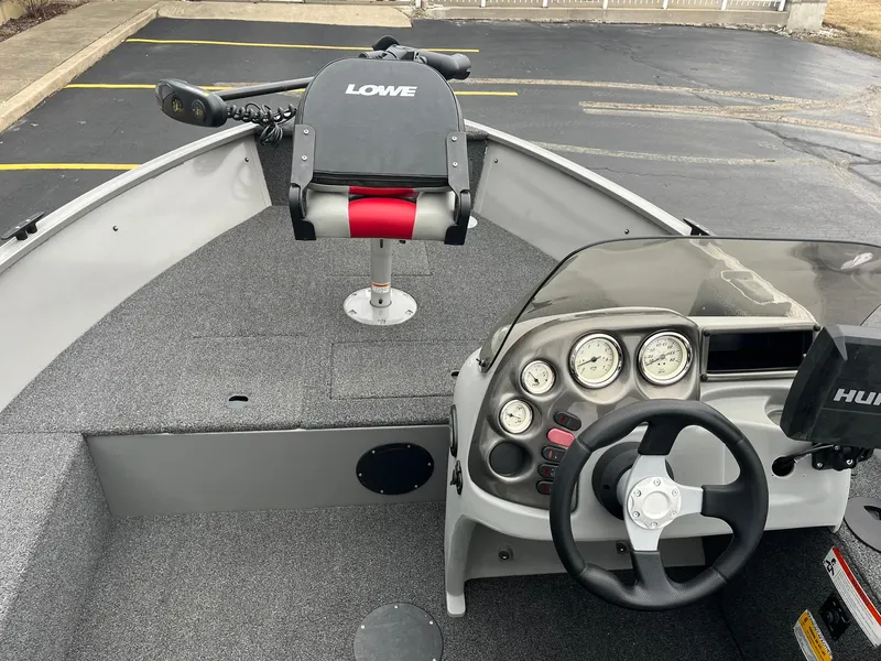 Slide: The Image of 2011 Lowe FM 165 boat interior with steering wheel and control panel. - 12