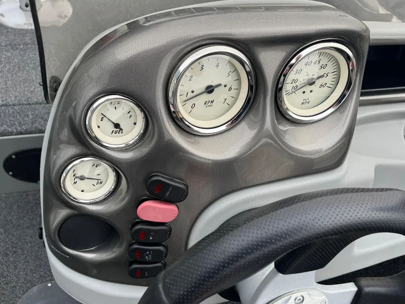 Slide: The Image of Dashboard of a 2011 Lowe FM 165 boat with gauges and controls. - 13