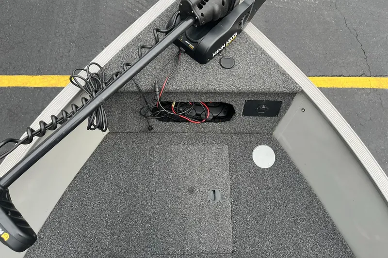 Slide: The Image of 2011 Lowe FM 165 boat interior with trolling motor and storage compartment. - 15