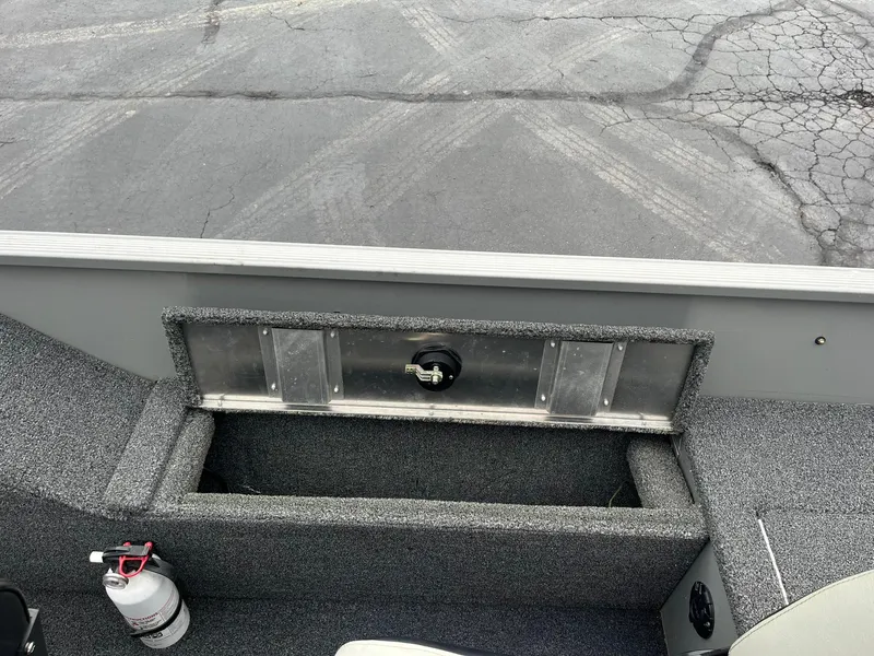 Slide: The Image of 2011 Lowe FM 165 boat interior with storage compartment and fire extinguisher. - 19