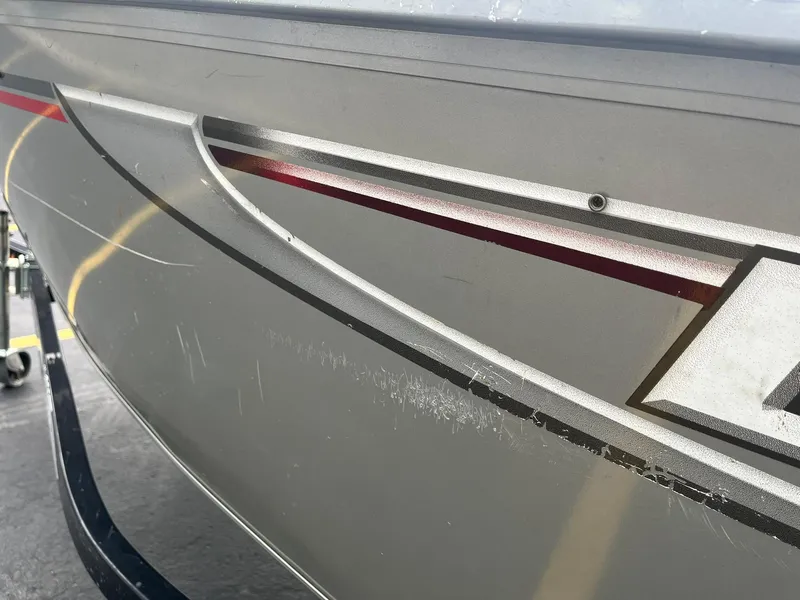 Slide: The Image of Close-up of a 2011 Lowe FM 165 boat hull with sleek design and graphics. - 27