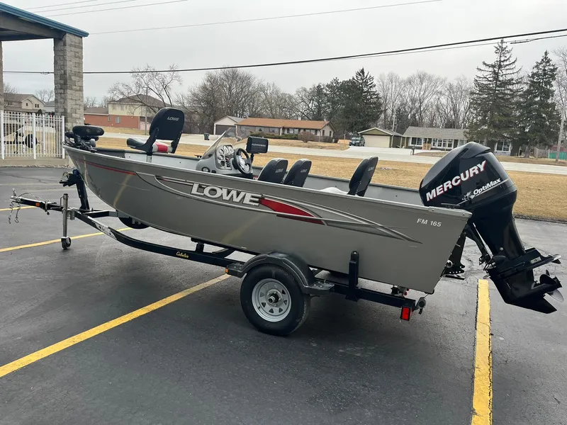 Slide: The Image of 2011 Lowe FM 165 fishing boat with Mercury outboard motor on trailer. - 3