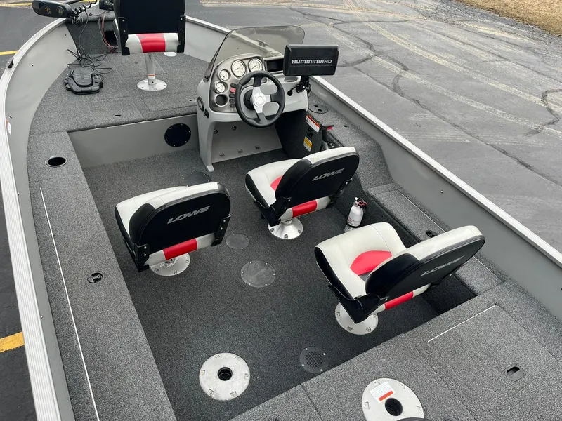 Slide: The Image of 2011 Lowe FM 165 boat interior with steering console and seating. - 5