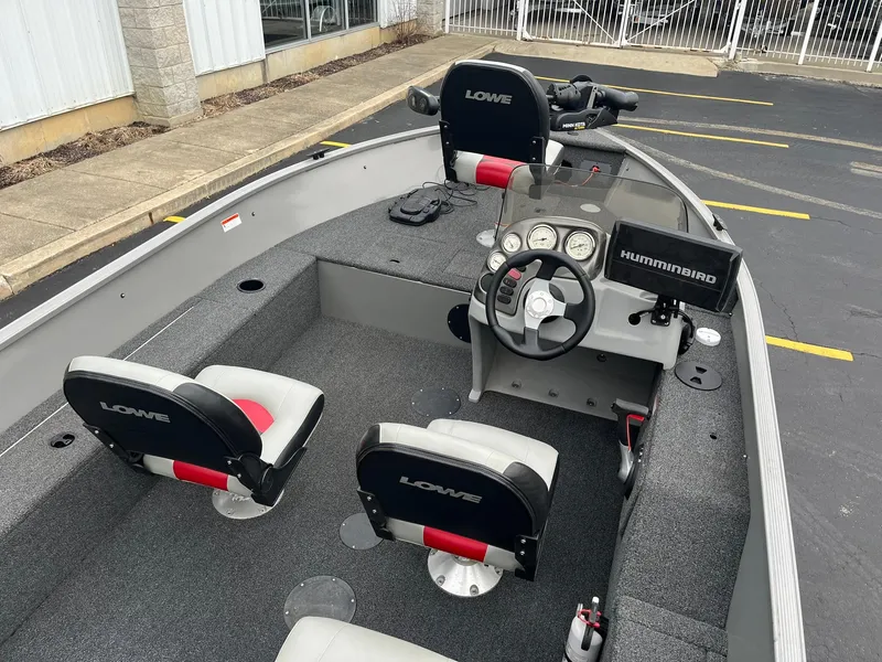 Slide: The Image of 2011 Lowe FM 165 boat interior with steering console and seating. - 6