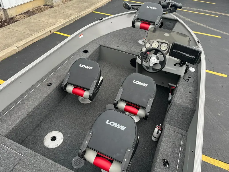Slide: The Image of 2011 Lowe FM 165 boat interior with steering console and seating. - 7