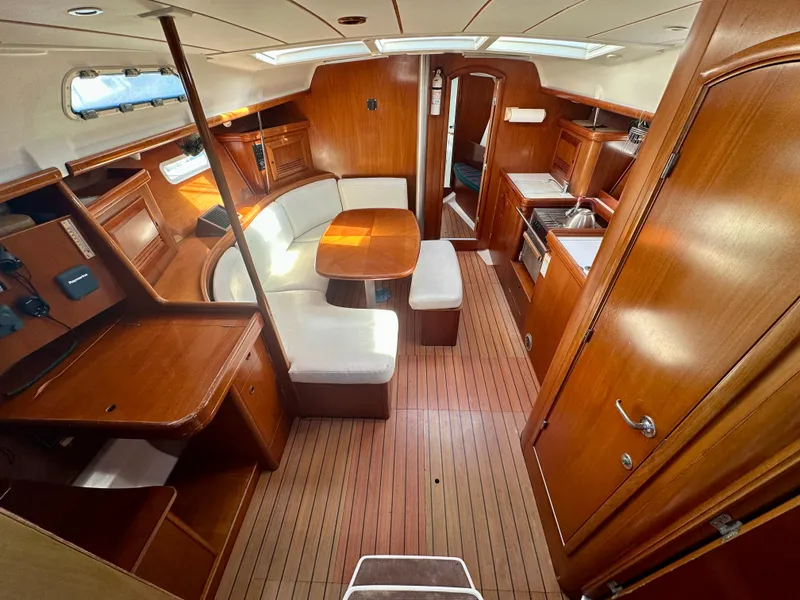 Slide: The Image of Interior of 2002 Beneteau Oceanis Clipper 393 yacht with wood finish and seating area. - 17