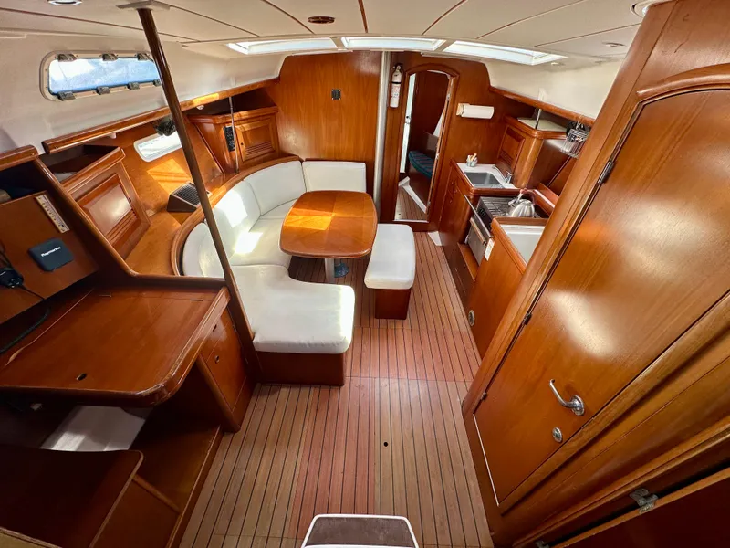 Slide: The Image of Interior of 2002 Beneteau Oceanis Clipper 393 yacht with wooden furnishings and seating area. - 18