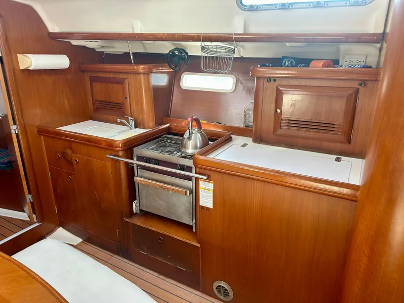 Slide: The Image of Interior of 2002 Beneteau Oceanis Clipper 393 yacht kitchen with wooden cabinetry and appliances. - 20