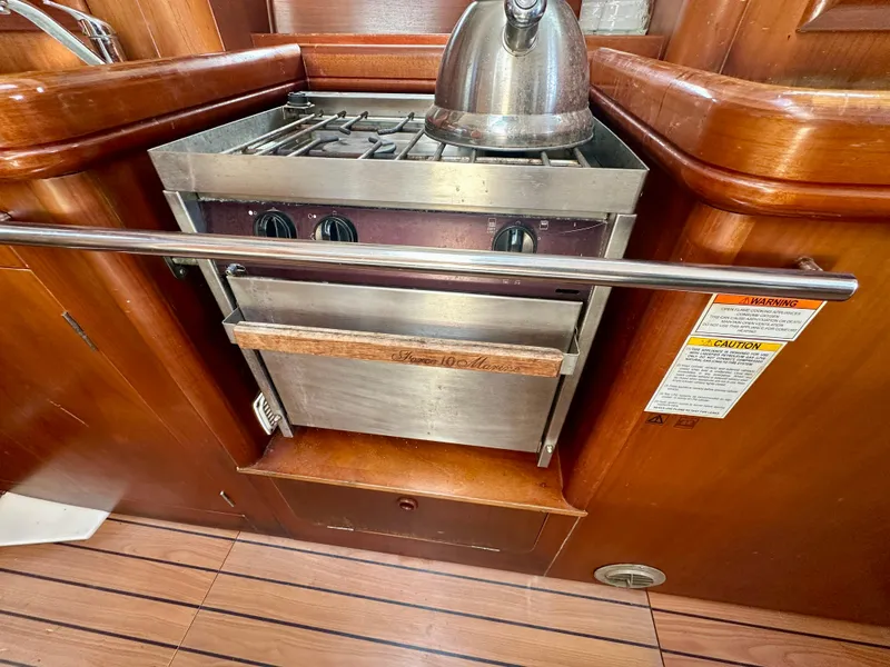 Slide: The Image of Beneteau Oceanis Clipper 393 yacht kitchen with stove and kettle, 2002 model. - 21