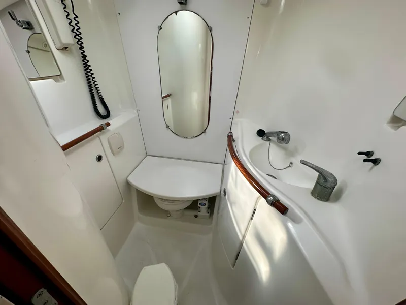 Slide: The Image of Beneteau Oceanis Clipper 393 2002 yacht bathroom with mirror, sink, and toilet. - 31