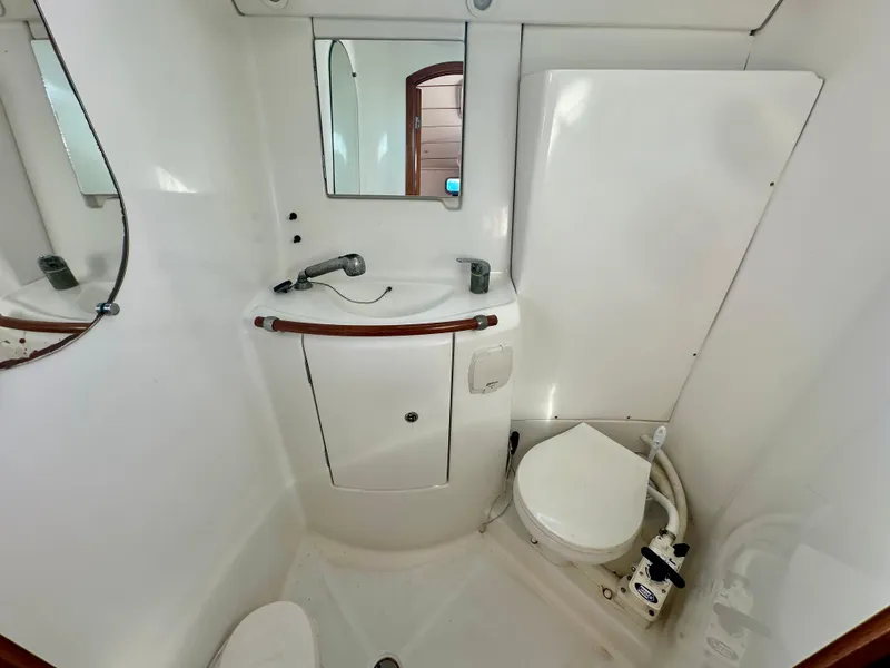 Slide: The Image of Compact bathroom in 2002 Beneteau Oceanis Clipper 393 yacht, featuring sink and toilet. - 35
